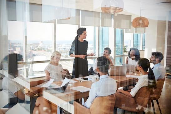 A person leading a meeting in an office